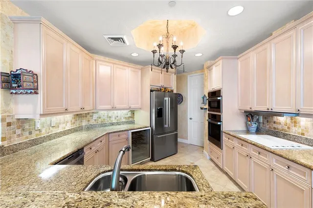 a kitchen with a sink stove and refrigerator