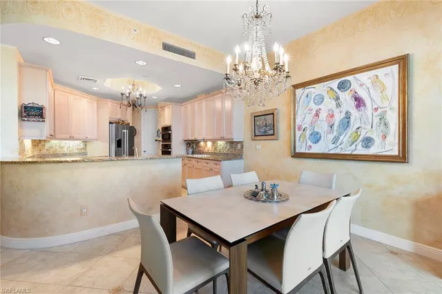 a view of a dining room with furniture and chandelier