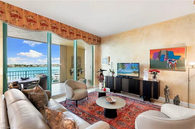 a living room with furniture a rug and a large window