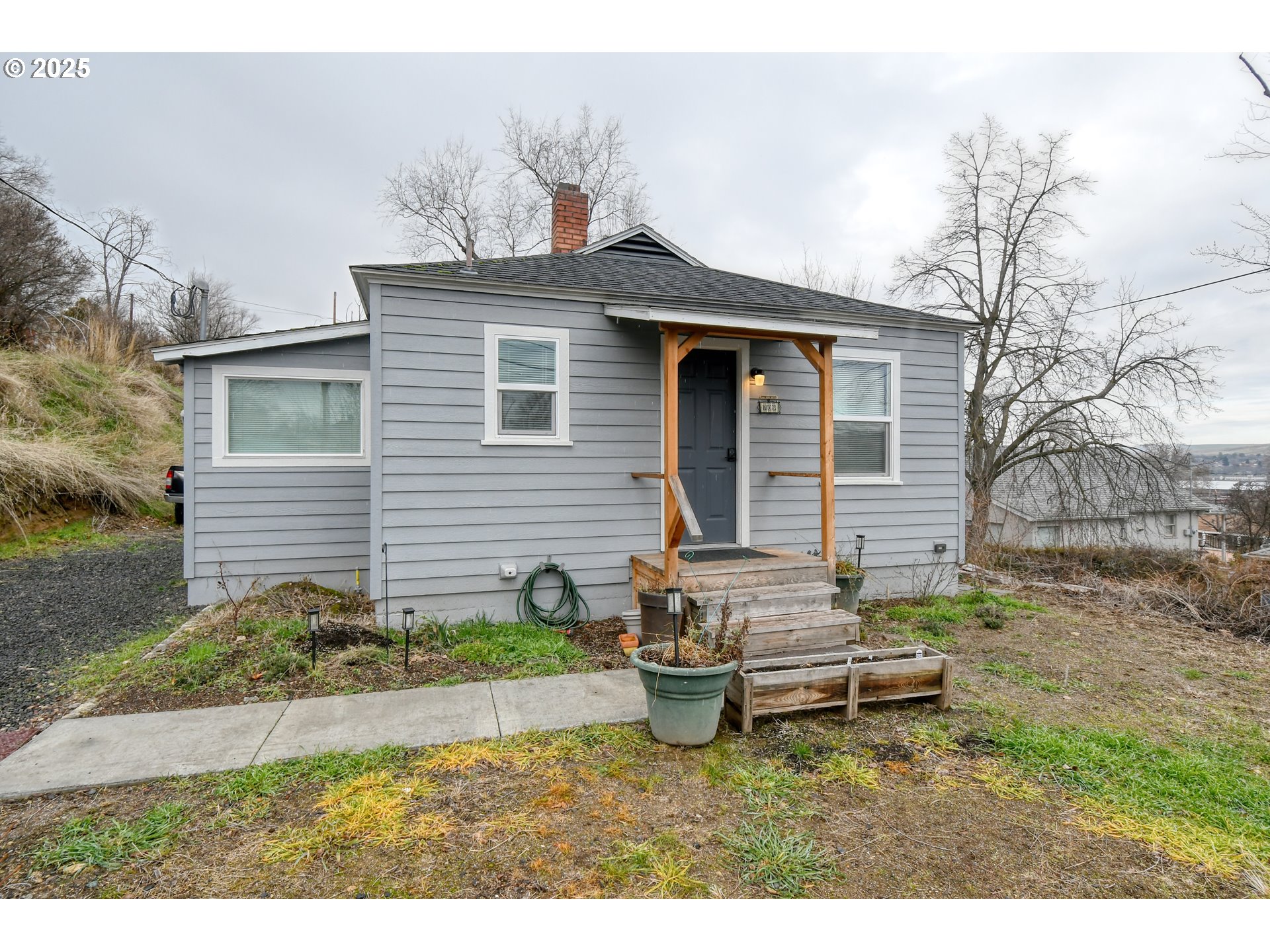 709 Southwest 8th Street Pendleton, OR 97801 - Photo 1 of 24 a backyard of a house with table and chairs