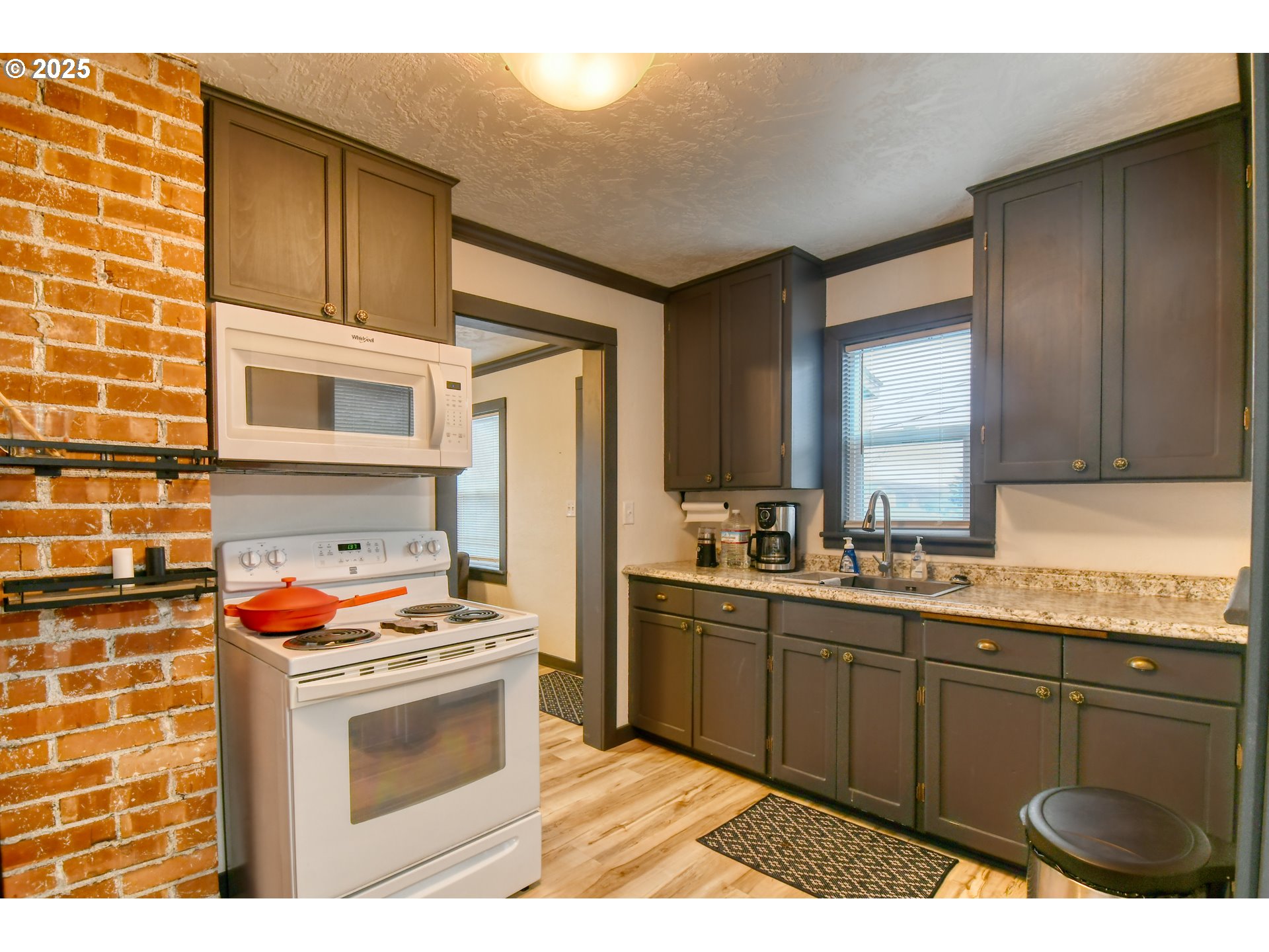 709 Southwest 8th Street Pendleton, OR 97801 - Photo 8 of 24 a kitchen with stainless steel appliances granite countertop a stove a sink and a microwave