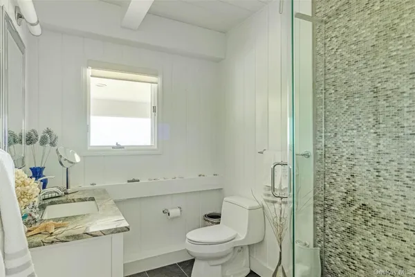 a bedroom with a bed and windows