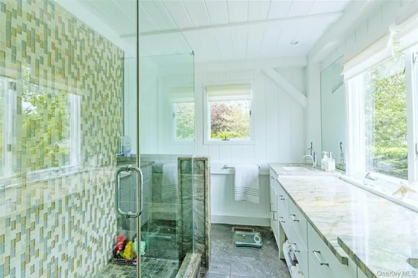 a bedroom with a bed and lamp painting on the wall