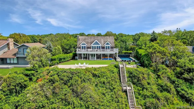 an aerial view of a house with a big yard and large trees