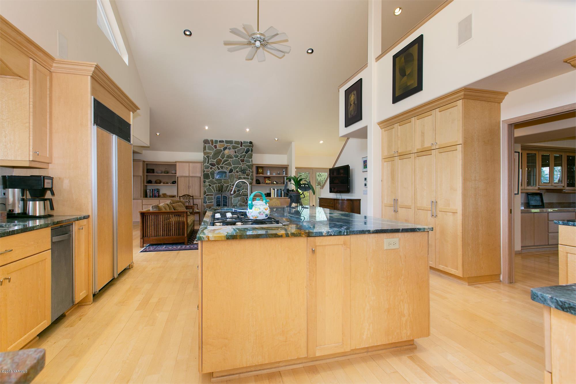13990 Gilbert Road Yakima, WA 98903 - Photo 11 of 29 a kitchen with stainless steel appliances granite countertop a refrigerator a sink dishwasher a stove with wooden cabinets and floor