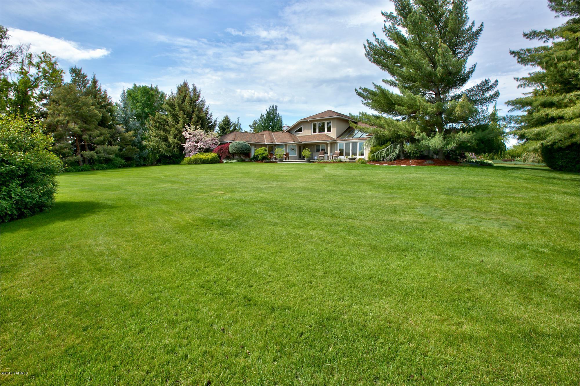 13990 Gilbert Road Yakima, WA 98903 - Photo 26 of 29 a view of house with garden space and trees