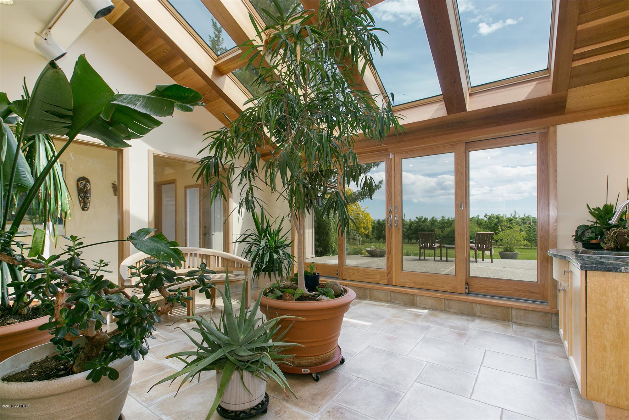 13990 Gilbert Road Yakima, WA 98903 - Photo 5 of 29 a view of a porch with plants and potted plants