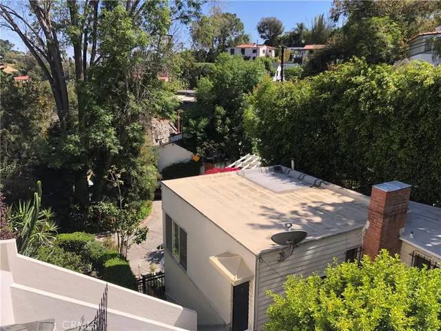 an outdoor space with seating area and trees
