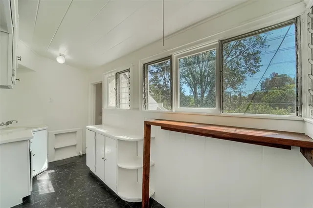 a view of an empty room with a fireplace and a large window