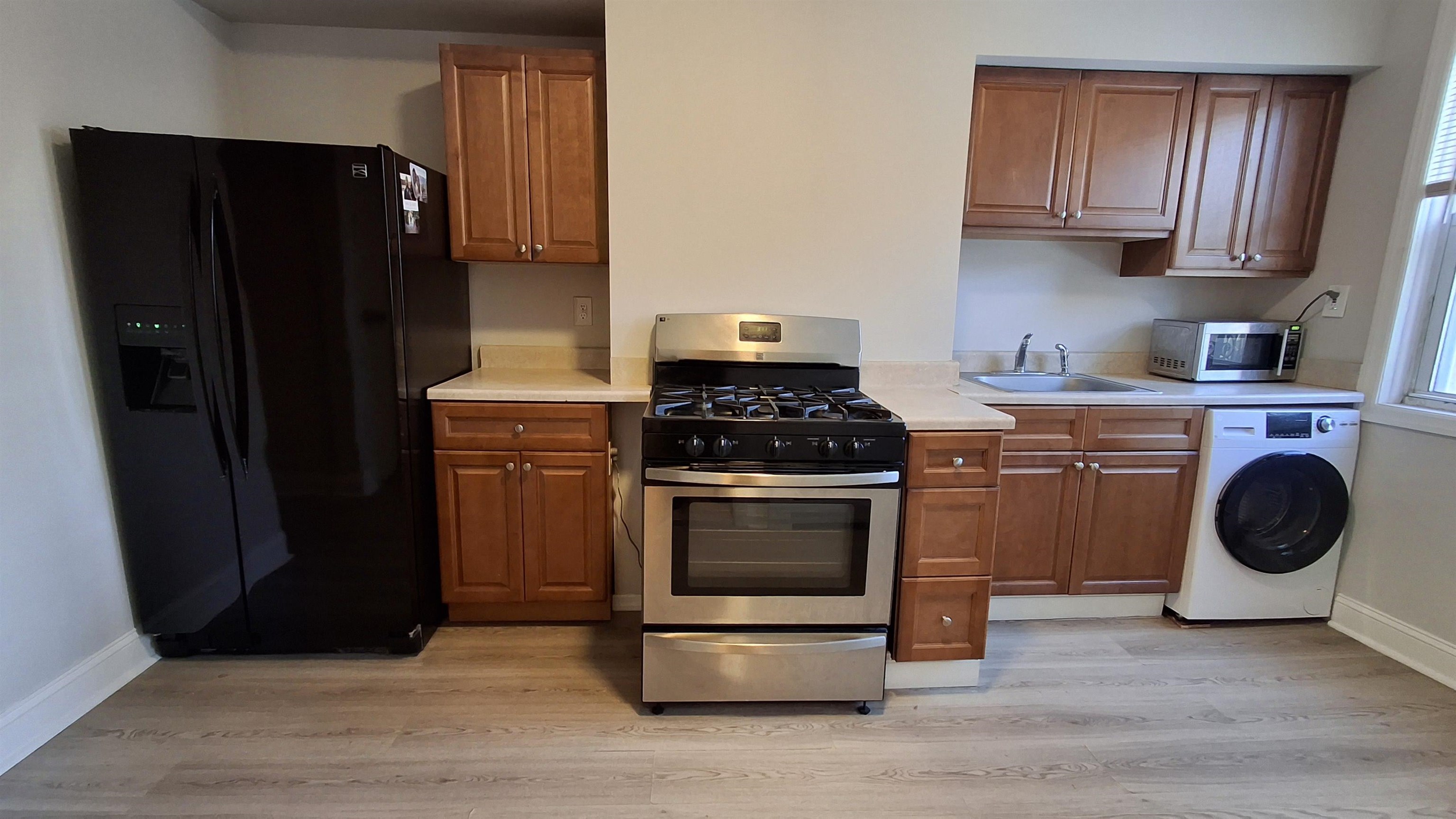 404 Madison Street, Unit 3L Hoboken, NJ 07030 - Photo 1 of 12 a kitchen with granite countertop wooden cabinets and a stove top oven