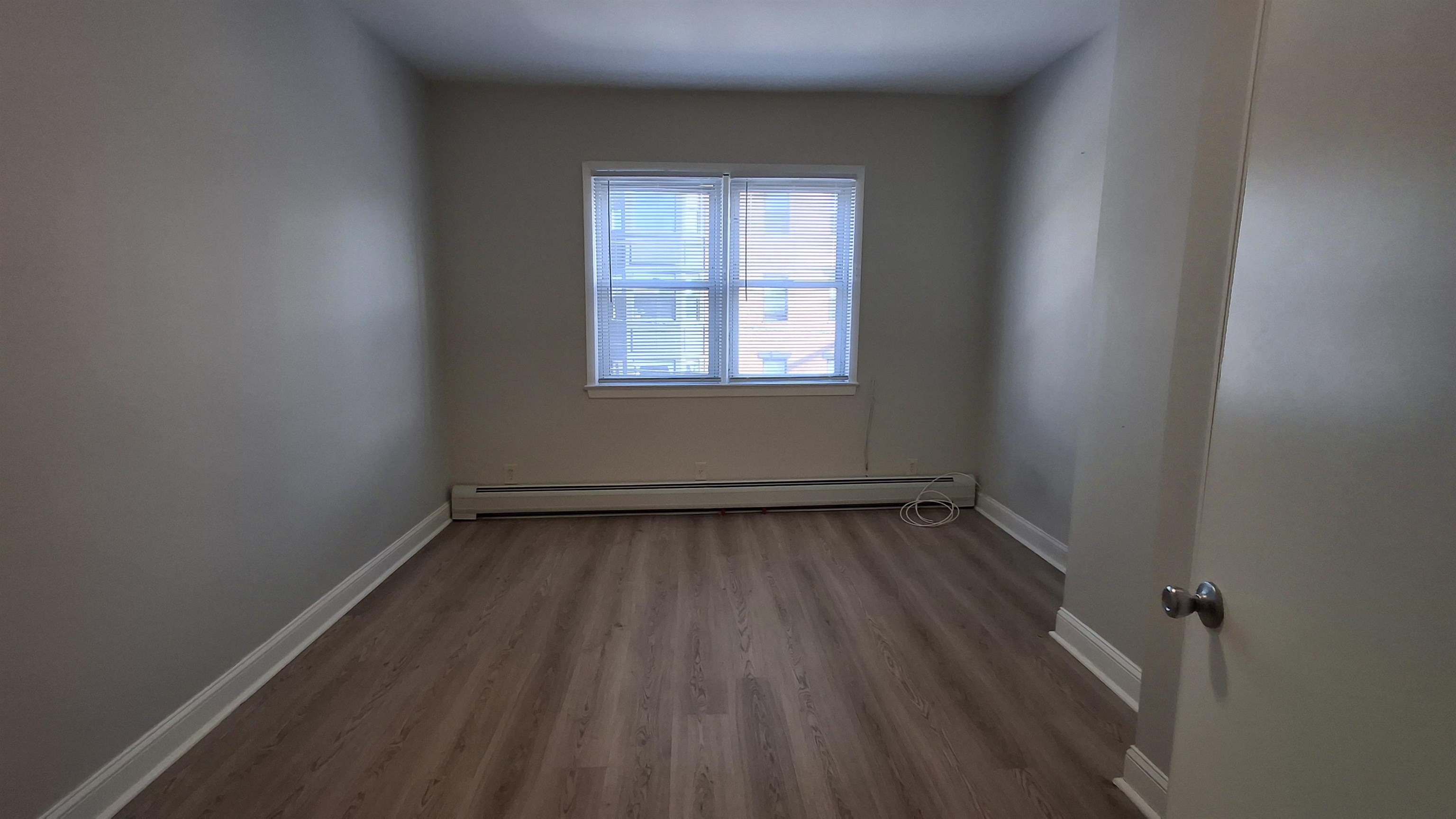 404 Madison Street, Unit 3L Hoboken, NJ 07030 - Photo 8 of 12 a view of a room with wooden floor and window
