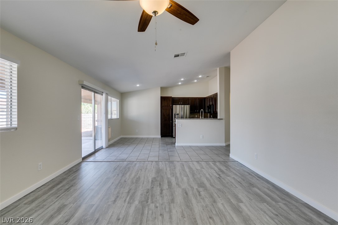 2028 Rustler Ridge Avenue North Las Vegas, NV 89031 - Photo 12 of 40 An open-concept layout features contrasting light wood and tile flooring, ideal for versatile living and entertaining.