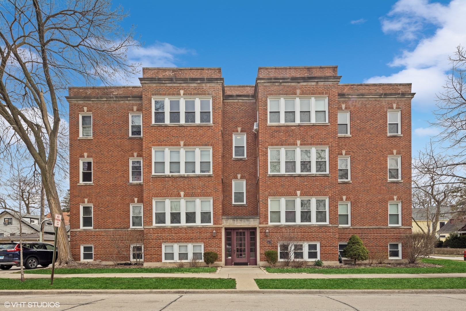 a front view of a residential apartment building with a yard