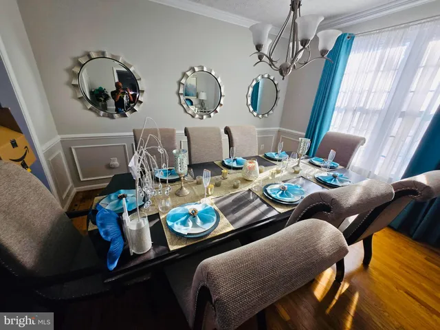 a dining room with furniture and wooden floor