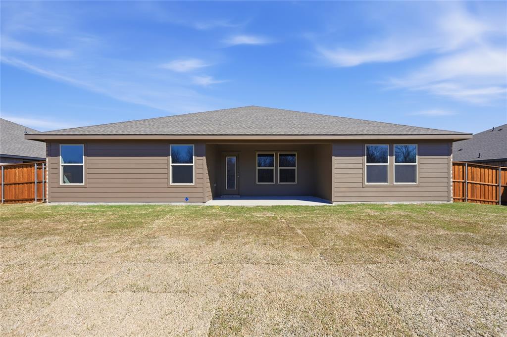 1907 Reveille Way Terrell, TX 75160 - Photo 6 of 6 Rear exterior featuring a covered patio, multiple windows, and a wood privacy fence