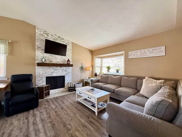a living room with furniture fireplace and flat screen tv