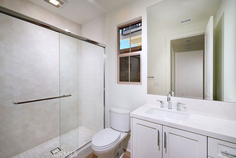 128 Oakstone Irvine, CA 92618 - Photo 6 of 13 a bathroom with a granite countertop sink toilet and shower