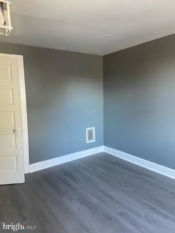 an empty room with wooden floor