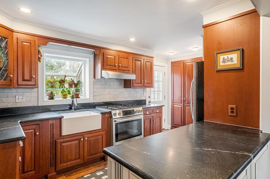 432 Weston Road Wellesley, MA 02482 - Photo 8 of 27 a kitchen with stainless steel appliances granite countertop a sink stove and refrigerator