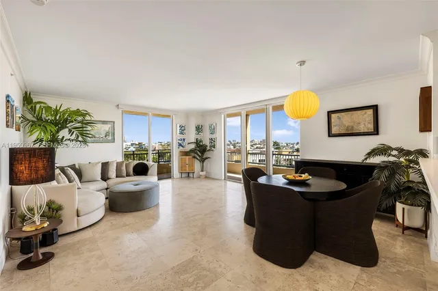 a living room with furniture kitchen view and a large window