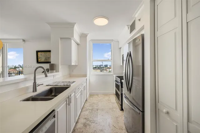 a kitchen with a sink and a refrigerator