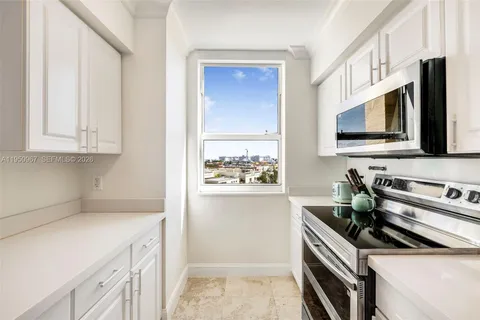 a kitchen with stainless steel appliances a stove a microwave a sink and cabinets