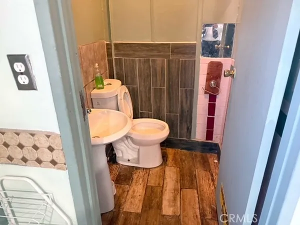 a bathroom with a toilet and a shower