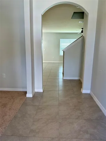 a view of a hallway with wooden shelves