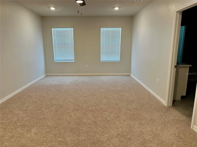 an empty room with windows and closet