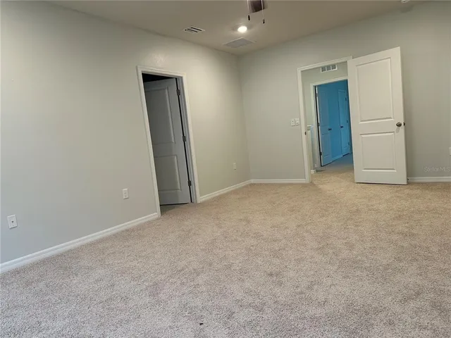 an empty room with closet and bathroom