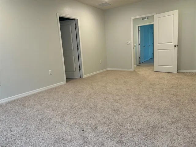 an empty room with closet area