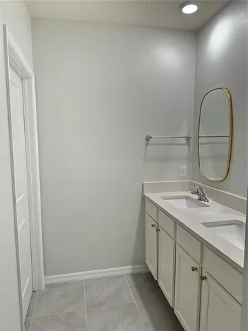 a bathroom with a granite countertop sink a toilet and a mirror