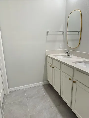 a bathroom with a granite countertop sink a mirror and a vanity