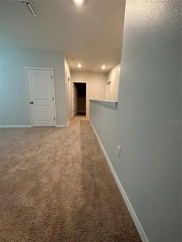 a view of hallway with an empty room