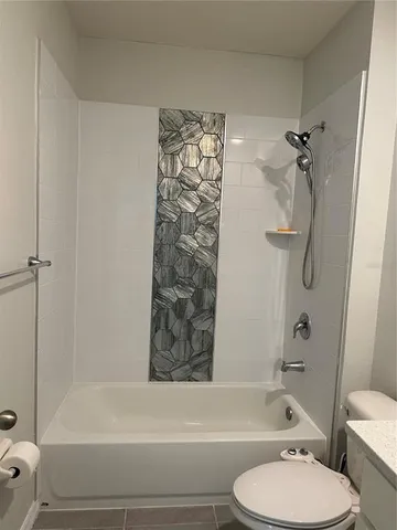 a bathroom with a toilet and a bathtub