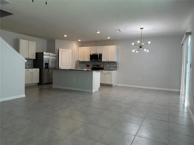 a kitchen with stainless steel appliances a refrigerator sink and stove