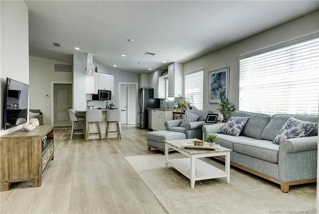 a kitchen with kitchen island granite countertop a sink stove and refrigerator