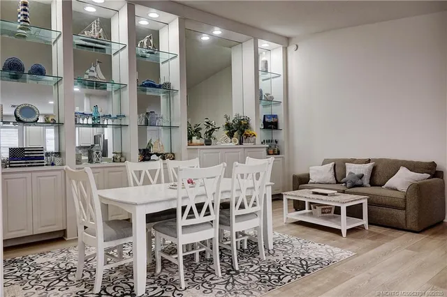 a bathroom with a granite countertop sink a toilet a large mirror and shower