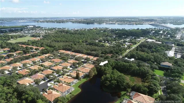 an aerial view of a house with a yard and lake view