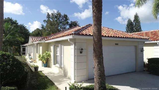 a view of backyard with plants and outdoor seating