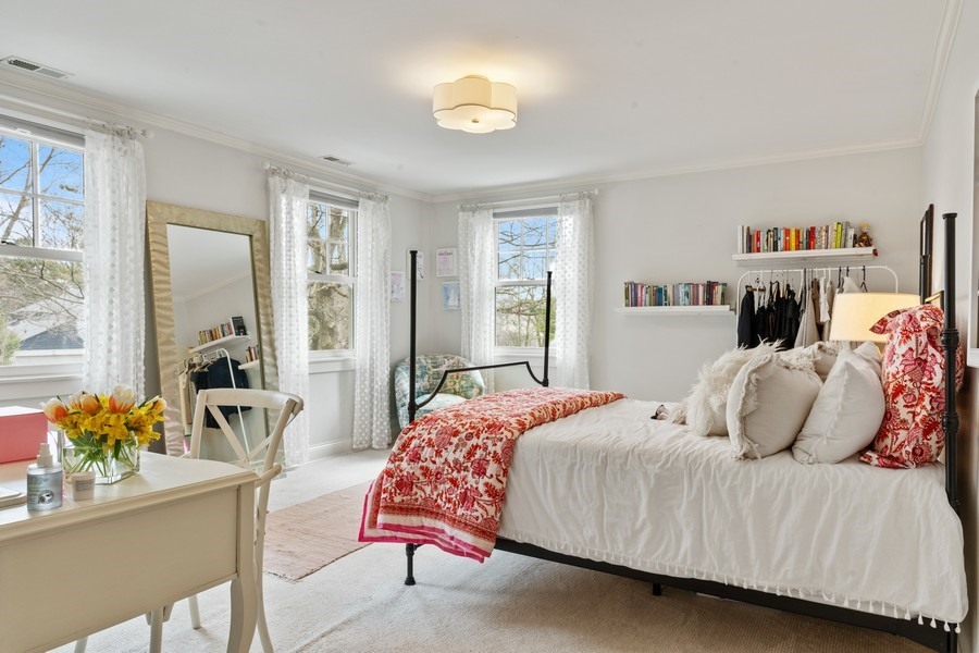 346 Sheridan Road Winnetka, IL 60093 - Photo 32 of 59 a bedroom with a bed and a chandelier
