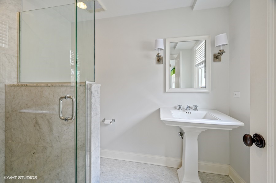 346 Sheridan Road Winnetka, IL 60093 - Photo 33 of 59 a bathroom with a sink a mirror a vanity and shower
