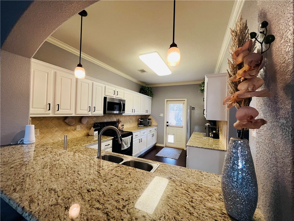 3203 Corporal Road College Station, TX 77845 - Photo 3 of 32 a living room with furniture a chandelier and a flat screen tv