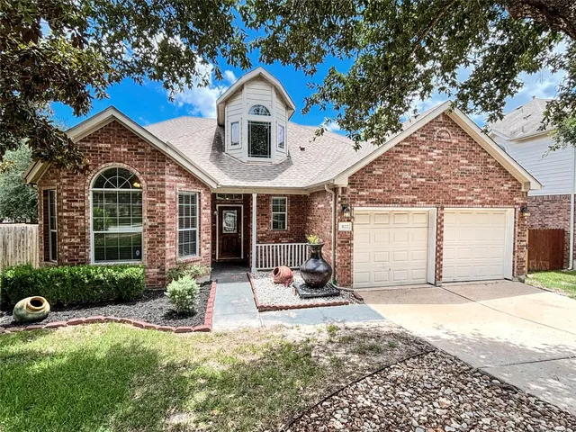 a front view of a house with a yard outdoor seating and garage