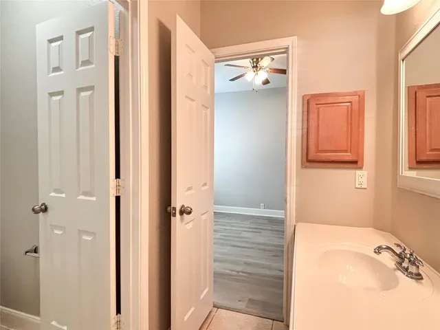 a bathroom with a tub shower and a sink