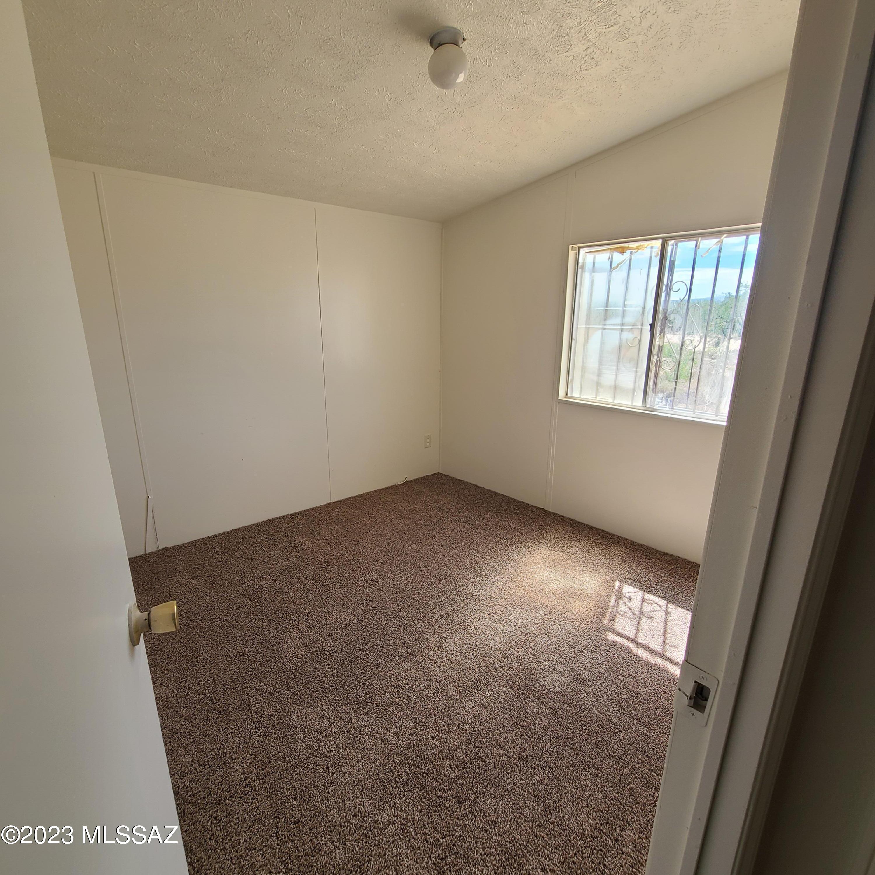 8896 South Marstellar Road Tucson, AZ 85736 - Photo 16 of 39 an empty room with windows