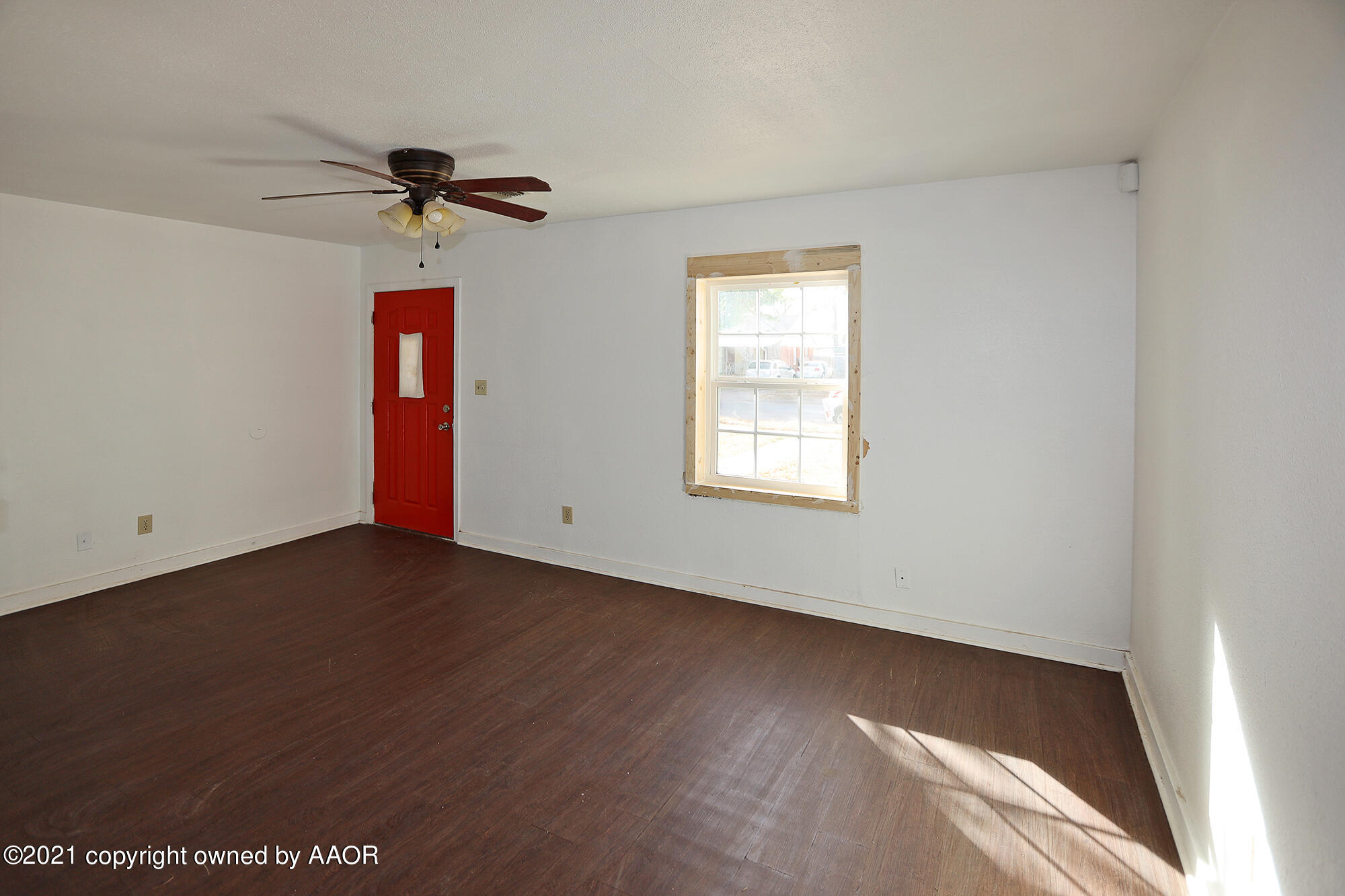 3603 South Ong Street Amarillo, TX 79110 - Photo 3 of 13 a view of a room with a window and a ceiling fan