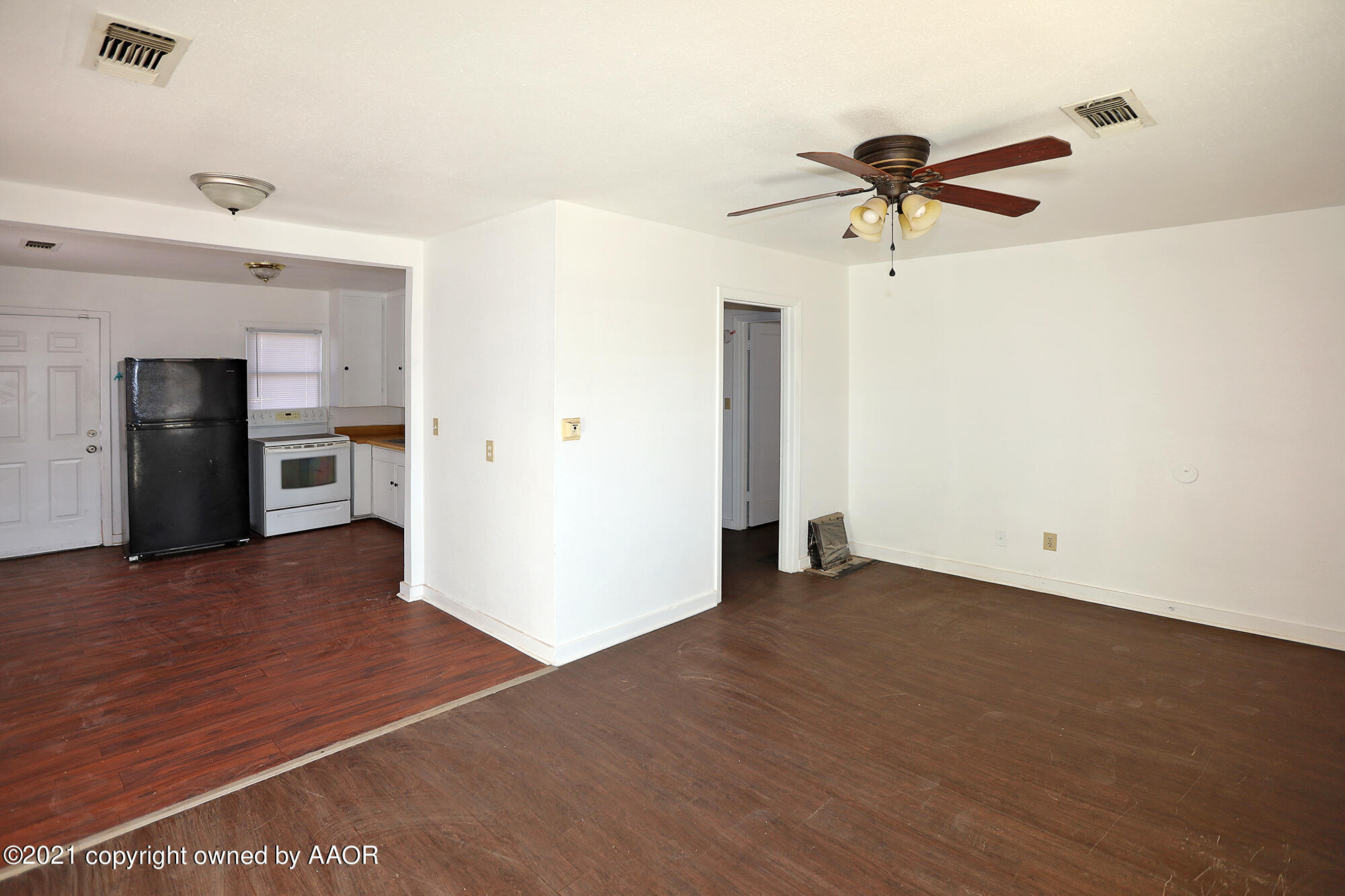 3603 South Ong Street Amarillo, TX 79110 - Photo 13 of 13 a view of empty room with wooden floor and ceiling fan
