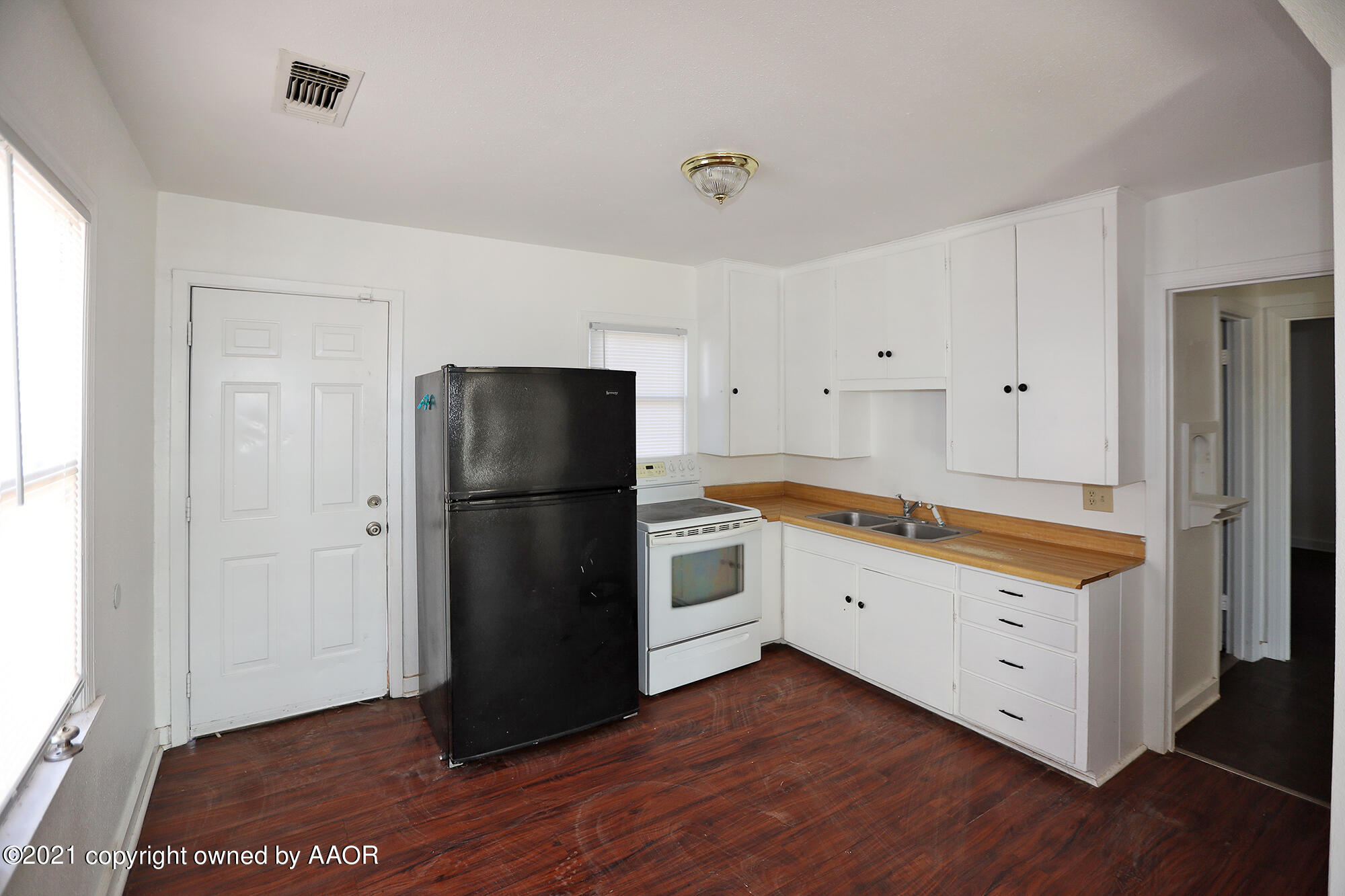 3603 South Ong Street Amarillo, TX 79110 - Photo 5 of 13 a kitchen with a refrigerator and a stove