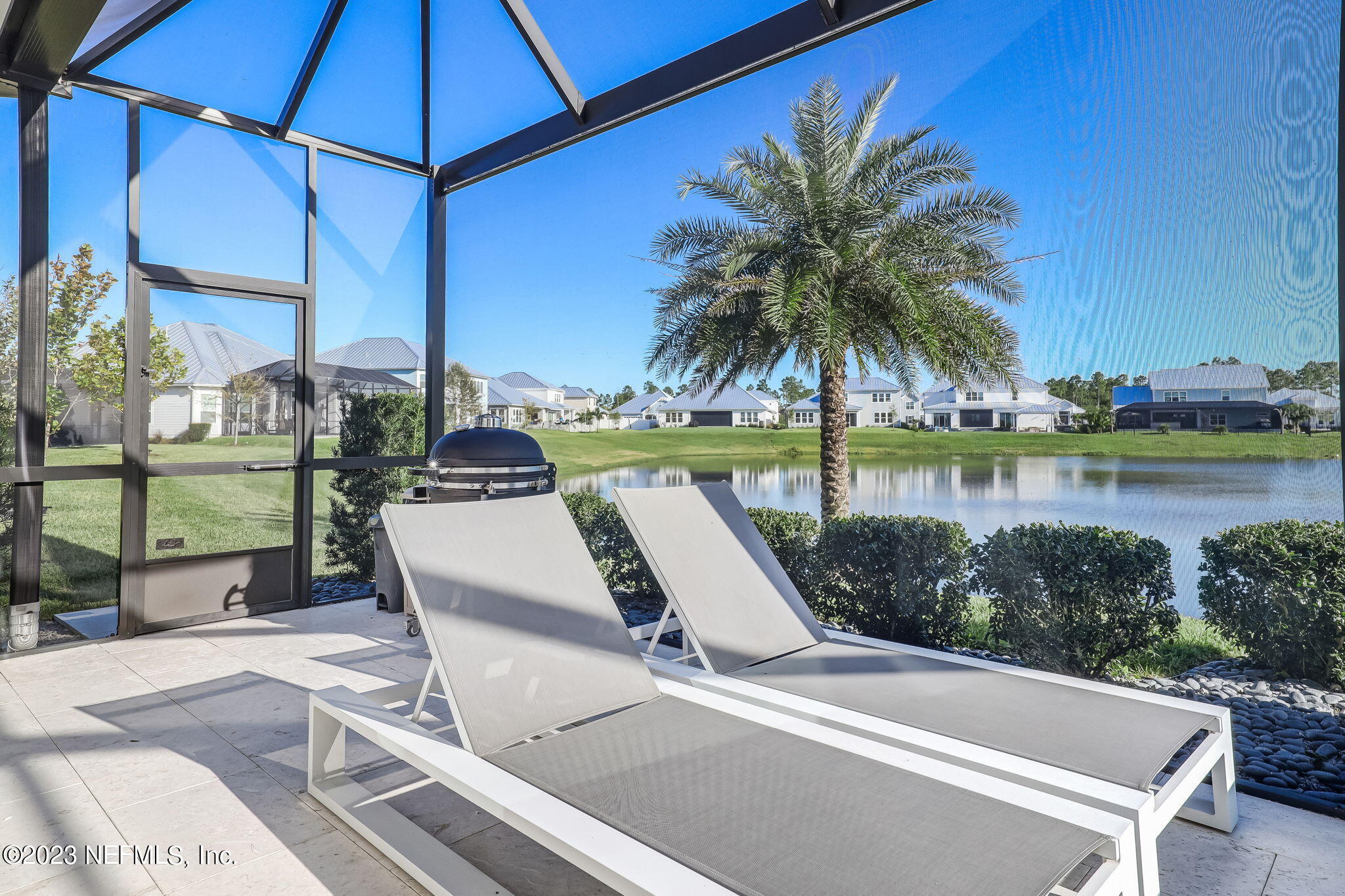 300 Topside Drive St. Johns, FL 32259 - Photo 67 of 121 a view of a patio with a table and chairs under an umbrella